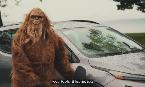 A still from the video Ensuring a Green Future with Responsible Practices where bigfoot stands in front of an electric vehicle.